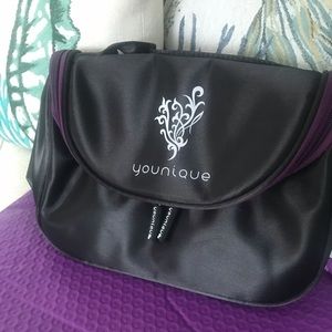 Younique makeup bag with brush holder in flap.